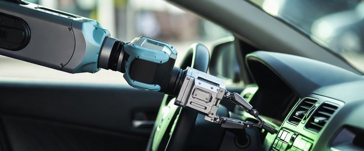 Robot arm interacting with vehicle controls